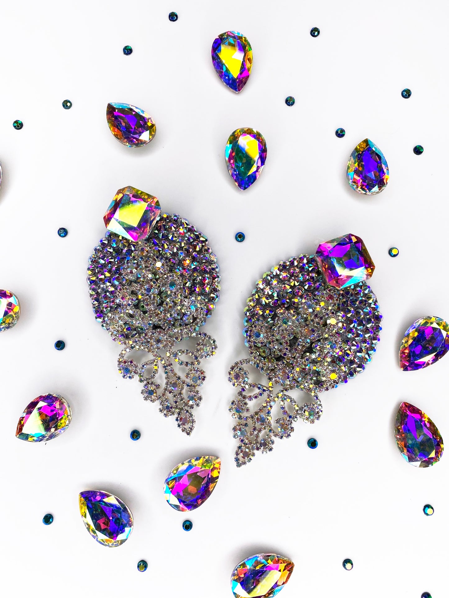 The Leading Lady earrings by Viva La Bombshell Burlesque feature large multicolored gems, accented with iridescent teardrop and round rhinestones—ideal for a dazzling look, especially when paired with crystal pasties.
