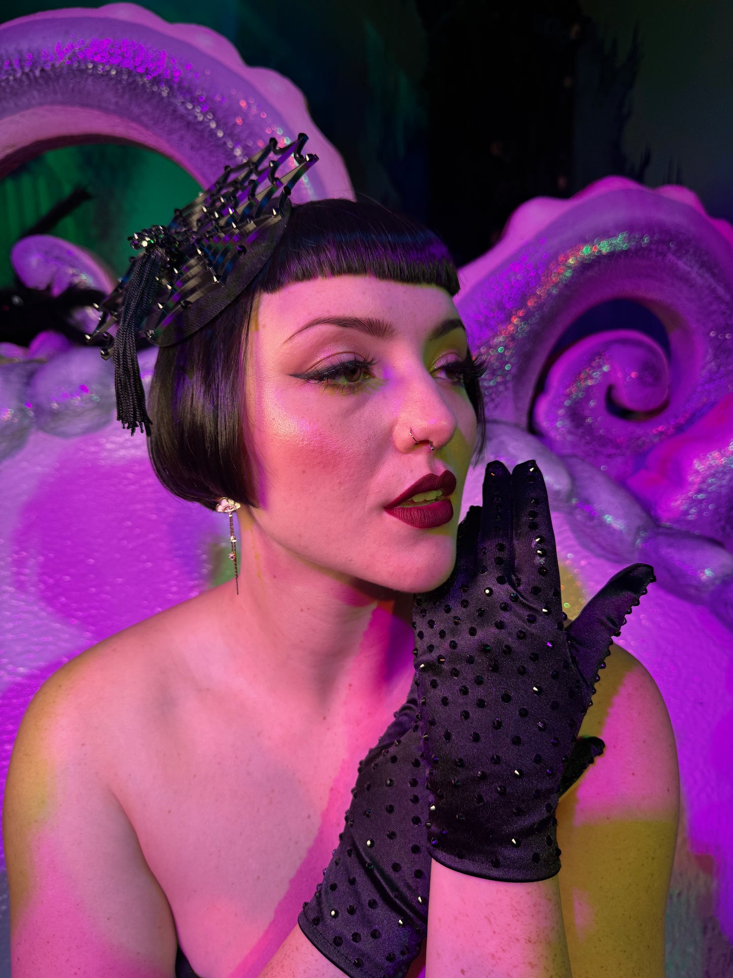 Cierra Bliss wearing classic short black rhinestone gloves with spider fascinator at the Golden Tiki