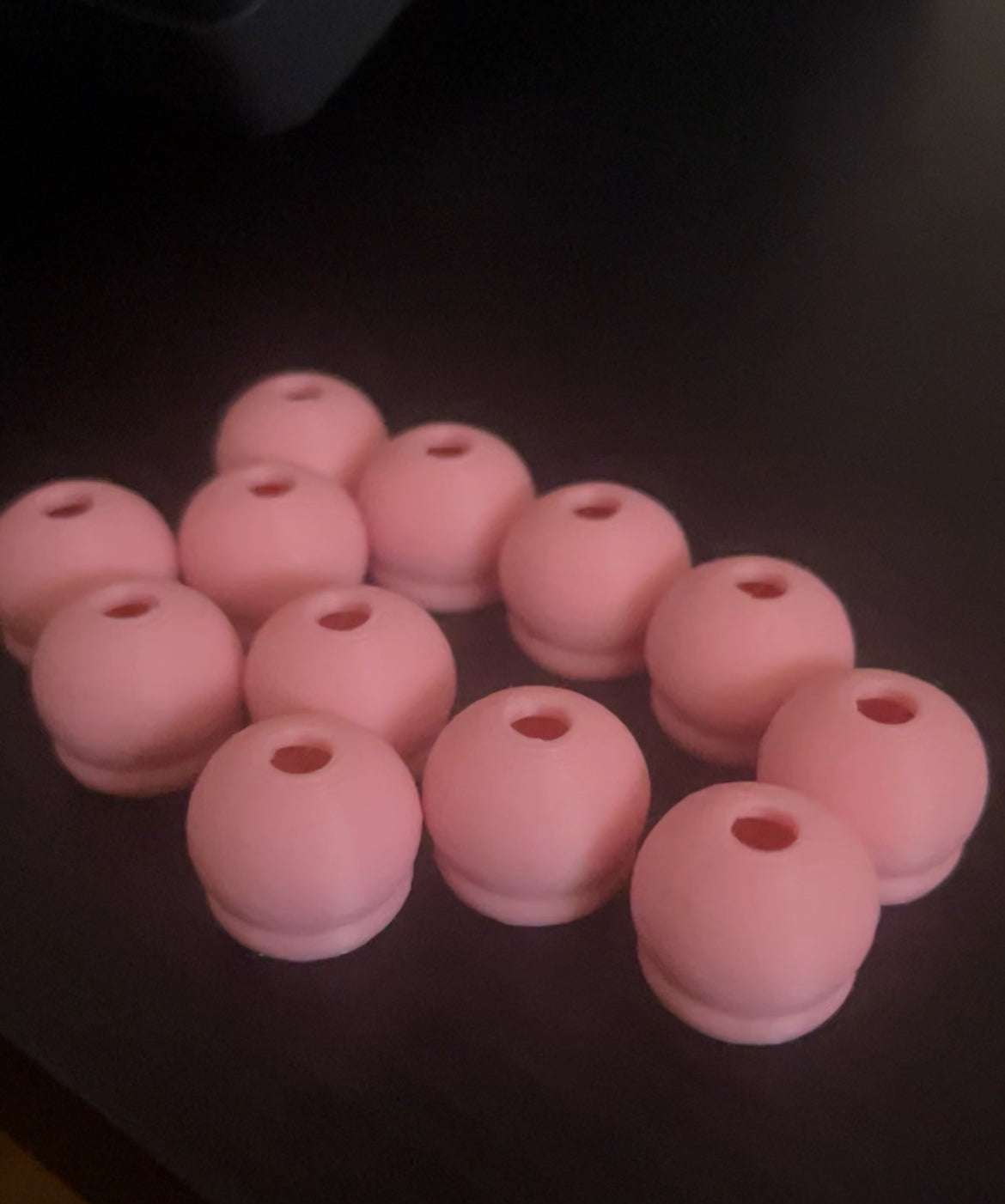Twelve small, round, pink Tassel Toppers Pasties from Viva La Bombshell Burlesque are displayed on a dark surface—ideal as bold accents for DIY 3D prints or creative projects.