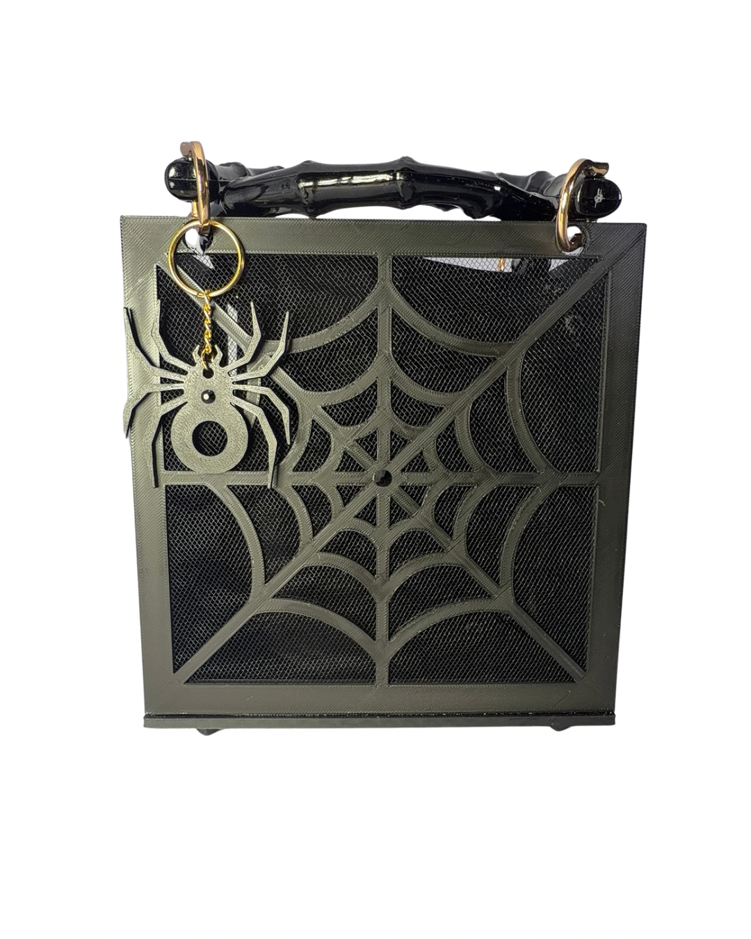 Introducing The Widow – Spiderweb Purse by Viva La Bombshell Burlesque: a chic black square handbag adorned with a bold spiderweb motif on the front, showcasing sophisticated bamboo handles and finished with a unique spider-shaped keychain accent.
