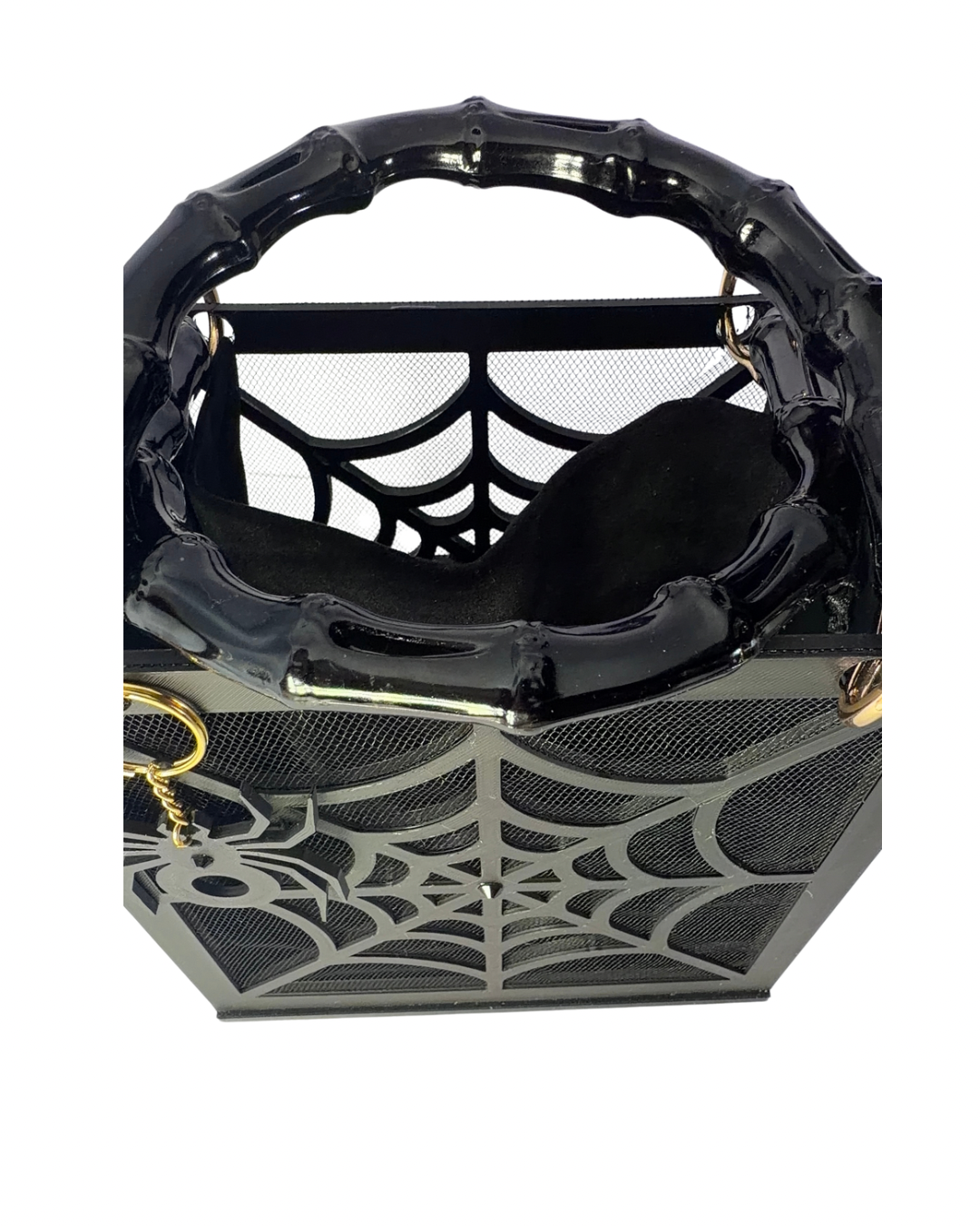 The Widow – Spiderweb Purse by Viva La Bombshell Burlesque is a black handbag featuring bamboo handles and a bold spiderweb motif on mesh panels, shown from above against a white background.