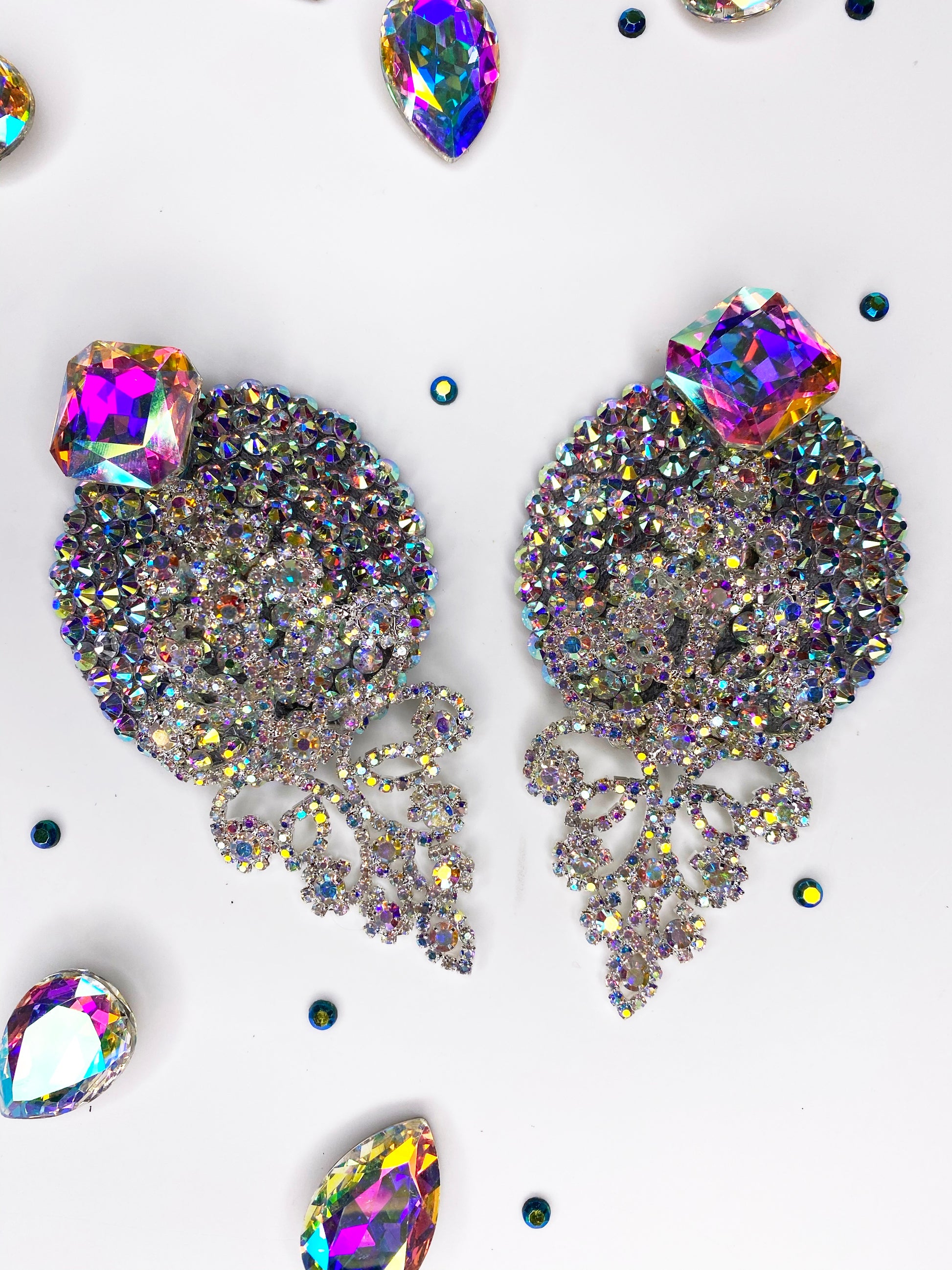 Add radiant sparkle to your look with Leading Lady earrings from Viva La Bombshell Burlesque, adorned with colorful stones reminiscent of crystal rhinestone pasties.