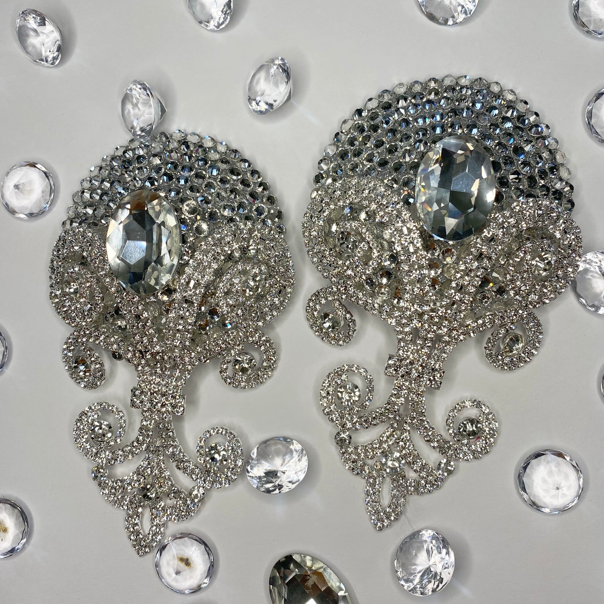 The Viva La Bombshell Burlesque Showstopper Pasties feature ornate silver jeweled designs with large central gems and crystal rhinestones, surrounded by clear gemstones on a light gray background.